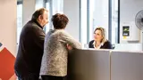 Man En Vrouw Aan De Balie Bij Haltewerk Receptionist