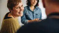 Lachende Vrouw Naar Man Met Op De Achtergrond Toekijkend Andere Vrouw